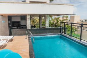 a swimming pool on the roof of a building at Terraço Flecheiras in Flecheiras