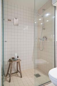 a bathroom with a shower and a sink and a toilet at Art Loft in downtown Oslo with Home Cinema in Oslo