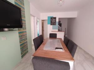 a dining room with a table and a flat screen tv at sambernardo in San Bernardo