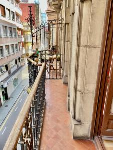 a balcony of a building with a table on it at TUNA PELLO in Gijón