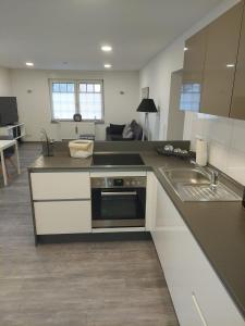 a kitchen with a stove and a sink in it at Ferienwohnungen Recklinghausen-Nord in Recklinghausen