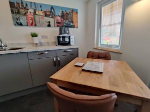 a kitchen with a wooden table and chairs at Bumble Bee Cabin in Bootle