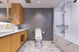 a bathroom with a toilet and a sink and a tub at Central Bangkok, 5 stars river view & characteristic decor in Bangkok +31 photos