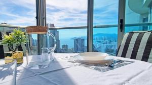a table with a bowl and a plate on a table with a view at Large and sunny all-day balcony with stunning sea views in Benidorm