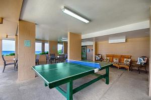 a room with a ping pong table in it at Kona Makai 3102 in Kailua-Kona