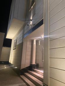 a building with stairs in front of it at night at MED Luxury Suites and Apparts in Al Madinah