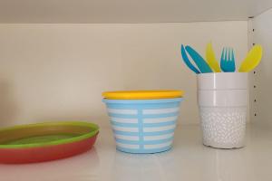 two cups and a bowl on a counter with utensils at Oeiras Historic Bedrooms in Oeiras