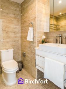 a bathroom with a toilet and a sink at Birchfort - Newly Renovated Huge 2 bedroom apartment in Dubai