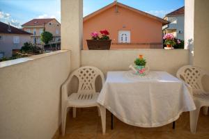 a white table and chairs on a balcony at Apartments Marko in Tivat