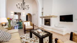 a living room with a couch and a fireplace at Casa Julia - Dunas Douradas in Faro