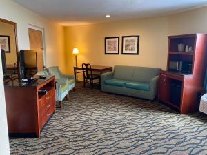 a living room with a couch and a tv at Outer Banks Inn in Kill Devil Hills