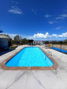 a large swimming pool with blue water at The Harmony Studio at Wind Walker Homestead in Spring City