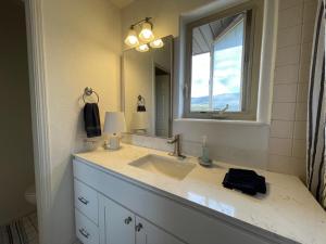 a bathroom with a sink and a mirror at The Harmony Studio at Wind Walker Homestead in Spring City