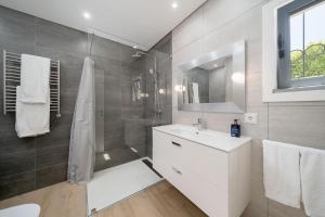 a bathroom with a white sink and a shower at Casa Alessa - Vale de Lobo in Almancil +15 photos
