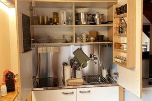 a kitchen with a stove top oven in a cabinet at Cottage sui colli Bolognesi in Bologna