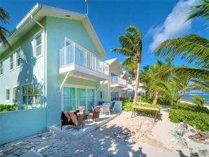 a house on the beach with palm trees at Azure Breeze # 6 in North Side