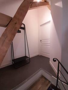 an empty room with a door and a treadmill at Le Repaire de Bacchus in Saint-Nicolas-de-Bourgueil