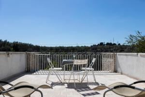 a pair of chairs and a table on a patio at B&B Samarelle - Exclusive Villa with Garden and Panoramic Terrace - Molfetta in Molfetta