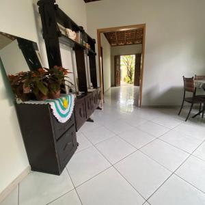 a kitchen with black cabinets and a white tile floor at Lazer Hostel in Barreirinhas