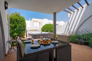 a table with food on it on a patio at Casa Maya - Vale do Garrão in Quinta do Lago