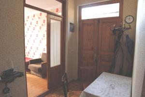 a hallway with a door and a room with a table at Guesthouse Pirosmani in Borjomi