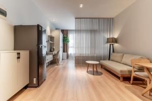 a living room with a couch and a table at The Rixx Lancaster Apartment @ D1/ Netflix/bathtub in Ho Chi Minh City