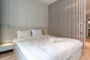 a white bed with a white tray on top of it at The Rixx Lancaster Apartment @ D1/ Netflix/bathtub in Ho Chi Minh City
