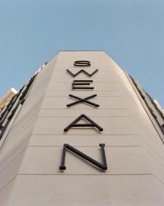 a clock on the side of a building at Hôtel Swexan in Dallas