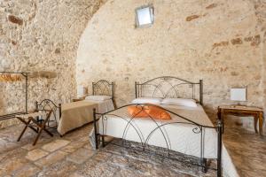 A bed or beds in a room at Antica Masseria San Benedetto