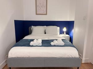 a bedroom with a bed with two slippers on it at La Belle Endormie - Louez L'Esprit Libre ! in Champs-sur-Marne