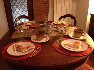 a wooden table with plates of food on it at Casina Mazzuoli in Città della Pieve