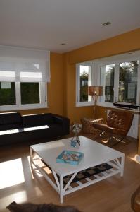 een woonkamer met een bank en een salontafel bij Villa Grillons in Koksijde