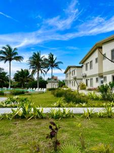 a house with palm trees and a grass yard at MiKiPi Hotel Boutique in La Vigueta