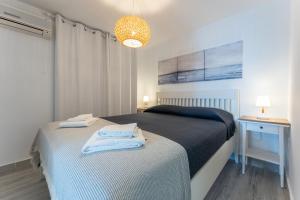 ミハスにあるSeafront Beach house Rocas del Marのベッドとランプ付きのテーブルがある寝室 +17枚の写真