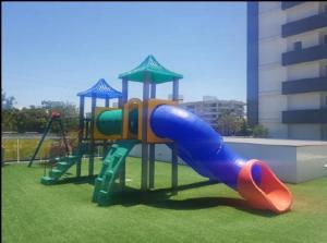 a playground with a slide in a park at Essence 516 em Atlântida in Xangri-lá