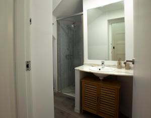 a bathroom with a sink and a mirror and a shower at ADDA Loft La Oficina in Alicante