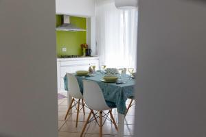 a kitchen with a table with a blue table cloth at B&B Samarelle - Exclusive Villa in Molfetta