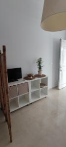 a room with a white cabinet with a potted plant on it at Neaktion Apartments in Nikiti