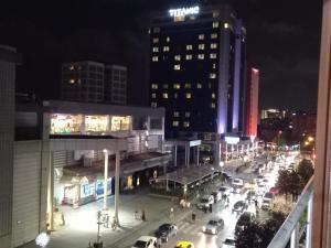 a busy city street at night with cars and buildings at Superhost! Bakirkoy, Shopping Malls and Cafes! in Istanbul