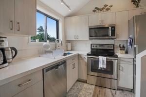a kitchen with stainless steel appliances and a window at Sealodge Villa H5 in Princeville