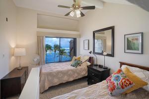 a bedroom with two beds and a window at Sealodge Villa H5 in Princeville