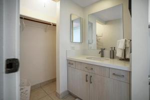 a bathroom with a sink and a mirror at Sealodge Villa H5 in Princeville +29 photos