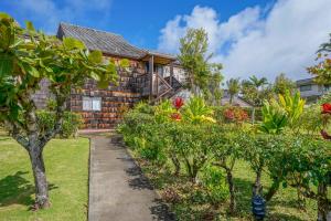 a house with a garden in front of it at Sealodge Villa H5 in Princeville