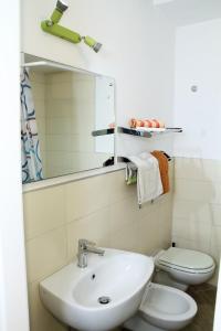 a bathroom with a sink and a toilet and a mirror at Lo studio di Nonno in Noci