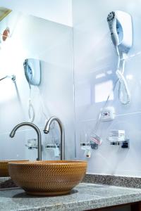 a bathroom sink with two faucets on a counter at Hotel Campestre Cordillera de los Andes in Villa de Leyva