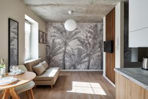 a living room with a large mural of palm trees at THE HOUSE near Lake & Old Town in Olsztyn