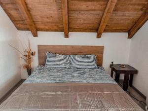 KavanaKunt في أراندجيلوفاك: سرير في غرفة ذات سقف خشبي