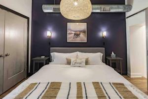 a bedroom with a large bed with purple walls at King Bed / Free Parking / BBQ / Fire pit / Arcade in Pittsburgh
