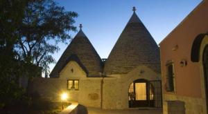 a building with two large towers on top of it at TRULLI ALLEGRETTI in Noci