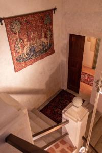 a stairway with a tapestry hanging on the wall at Castello di Castellengo in Cossato